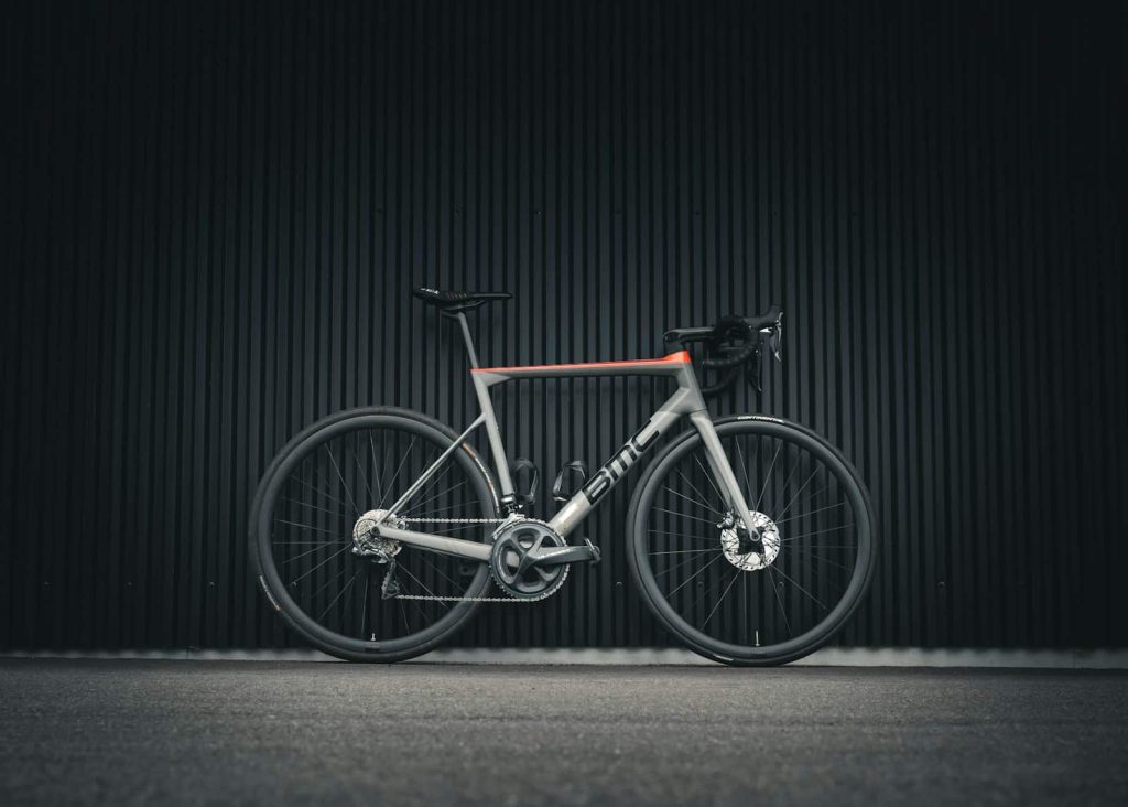 a bike parked in front of a black wall