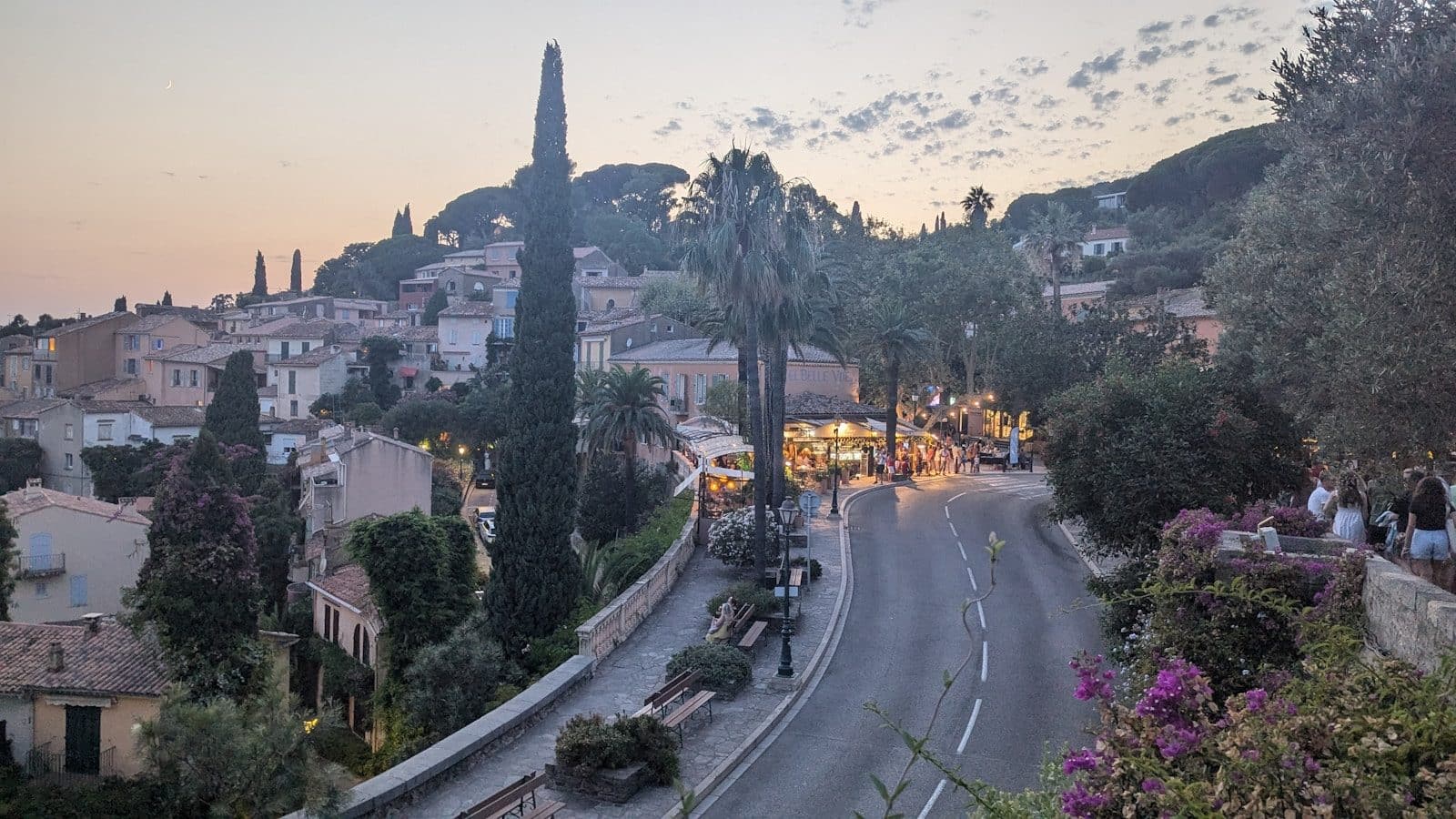 A view of a street with a hill in the background