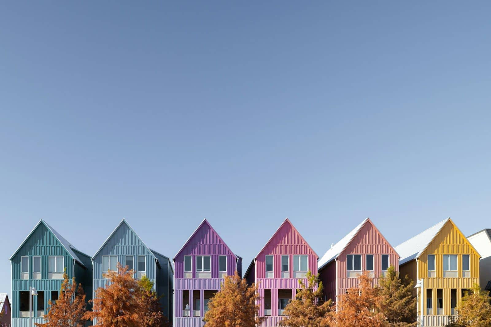 Colorful houses line a bright blue sky